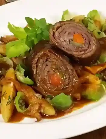 Rouladen mit leckerer Beilage Gemüse, serviert mit geschmorten Kartoffeln, Rosenkohl und aromatischer Soße.
