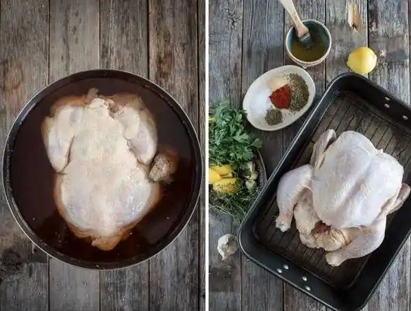 Rohes ganzes Hähnchen in Brine und vorbereitet mit Kräutern, Gewürzen und Zitrone für halbes Hähnchen im Backofen Rezept.