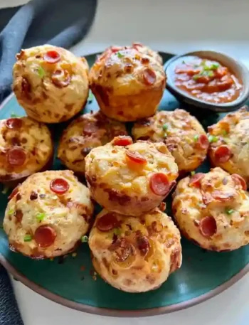 Pizza Muffins mit Peperoni auf grünem Teller – schnelle Pizzamuffins als herzhafte Muffins Pizza mit Dipsauce.