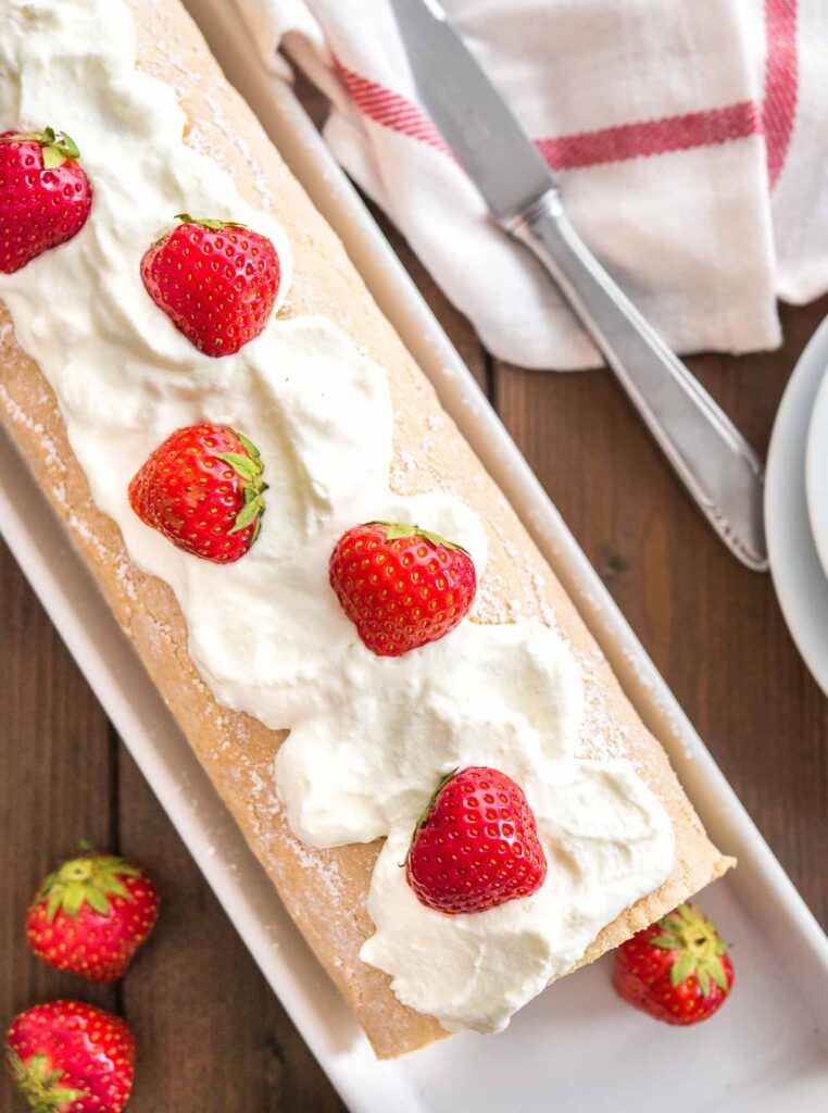 Biskuitrolle mit Erdbeeren und Sahne – klassisches Rezept für Erdbeer Biskuitrolle mit fluffigem Biskuit und frischer Sahnefüllung