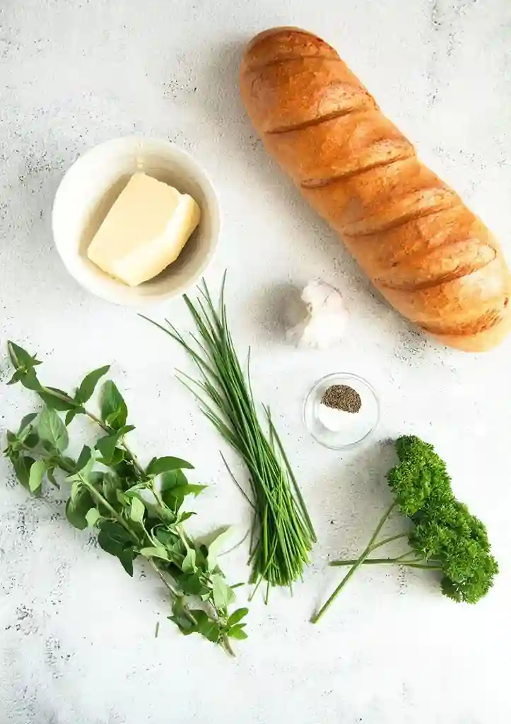 Zutaten für Kräuterbaguette: Baguette, Butter, Knoblauch, Petersilie, Schnittlauch, Oregano, Salz und Pfeffer