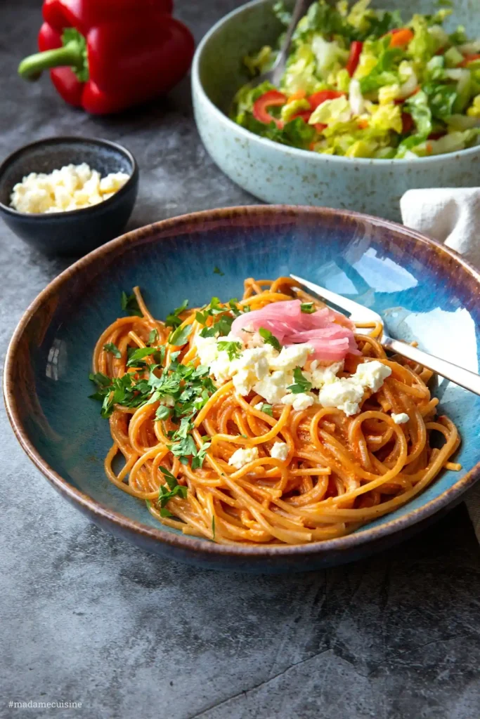 Spaghetti mit cremiger Paprika-Feta-Soße in einer blauen Schale – eine aromatische, leckere Soße für Pasta aus der Kategorie kreative Nudelsoßen Rezepte.