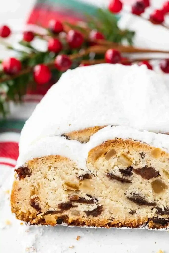 Aufgeschnittener Dresdner Stollen mit Marzipan und Puderzucker – Omas Christstollen Rezept mit Rumrosinen, Zitronat und Orangeat.
