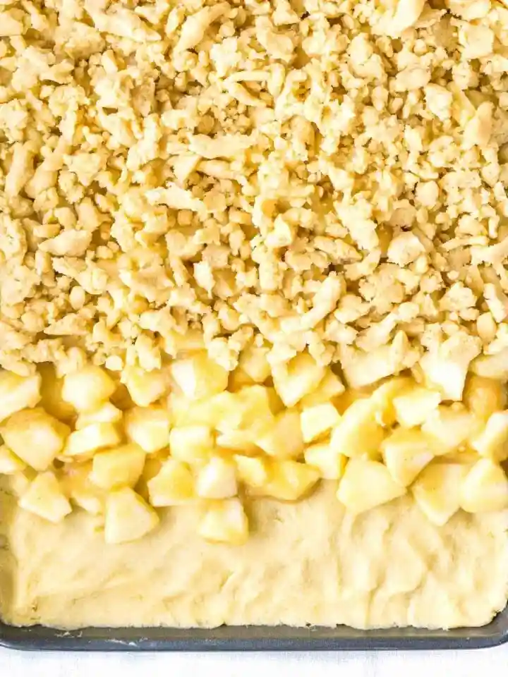 Apfelkuchen mit Streusel vom Blech vor dem Backen mit saftigem Rührteig, Apfelstücken und Streuseln