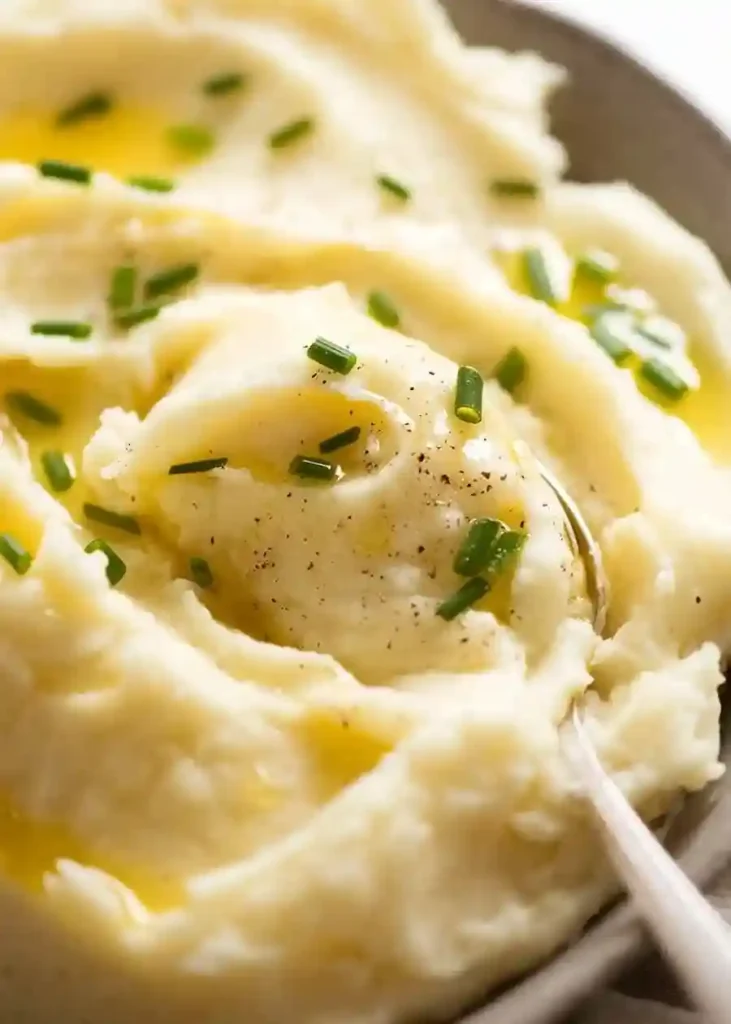 Löffel mit cremigem Kartoffelpüree mit Butter und Schnittlauch – klassisches Kartoffelpüree Rezept zum Kartoffelpüree selber machen