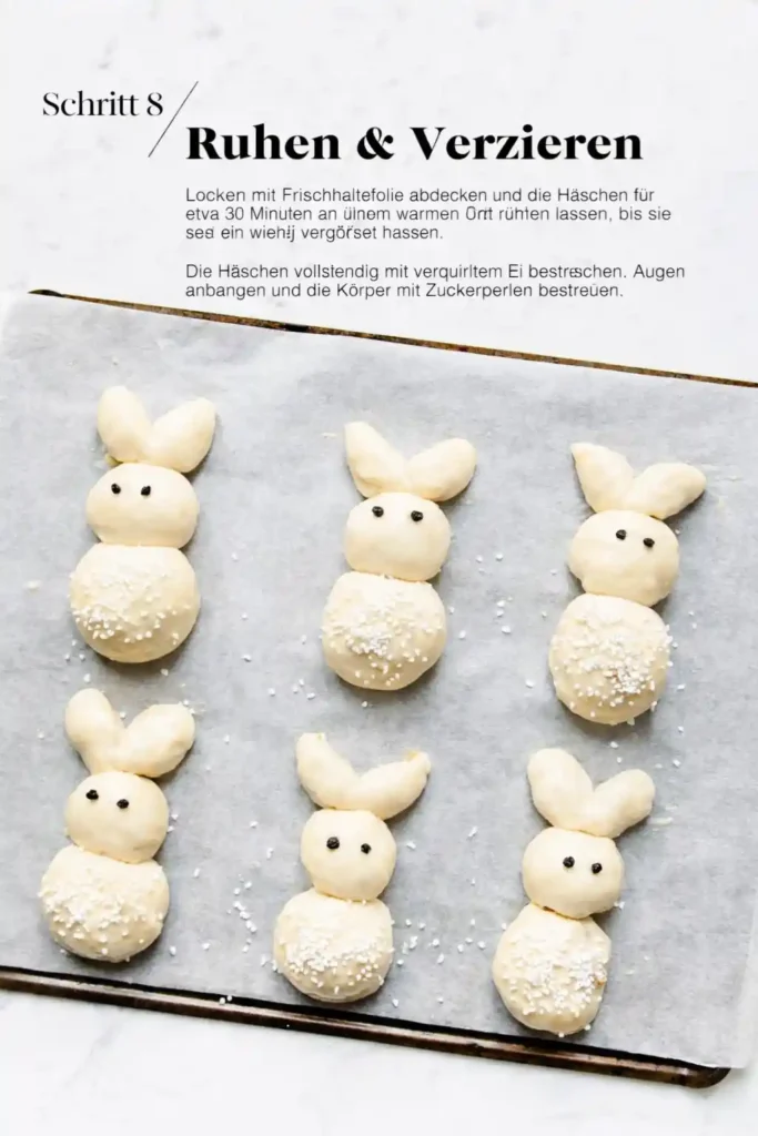 Osterhasen aus Hefeteig ruhen lassen und verzieren – Hefehasen vor dem Backen mit Ei bestreichen und Zuckerperlen dekorieren
