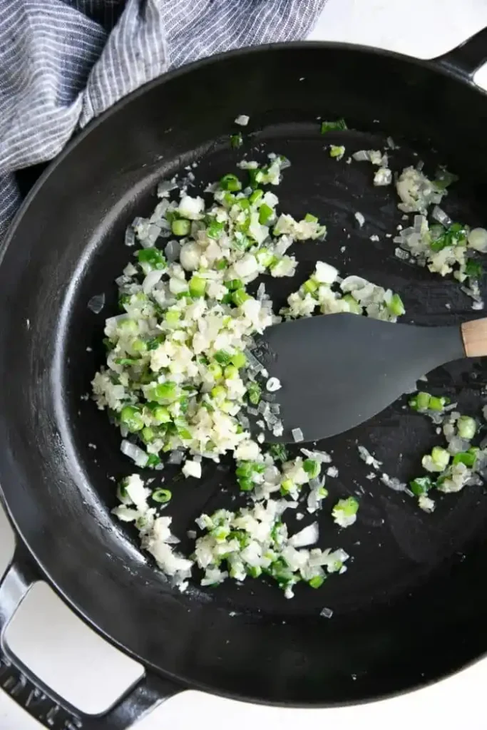 Zwiebeln, Knoblauch und Frühlingszwiebeln in der Pfanne anbraten – Basis für Pak Choi mit Hähnchen Pfanne