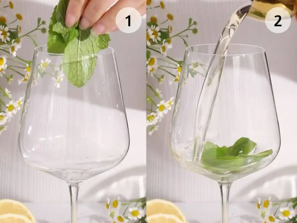 Hugo alkoholfrei zubereiten mit frischer Minze und Holunderblütensirup im Weinglas