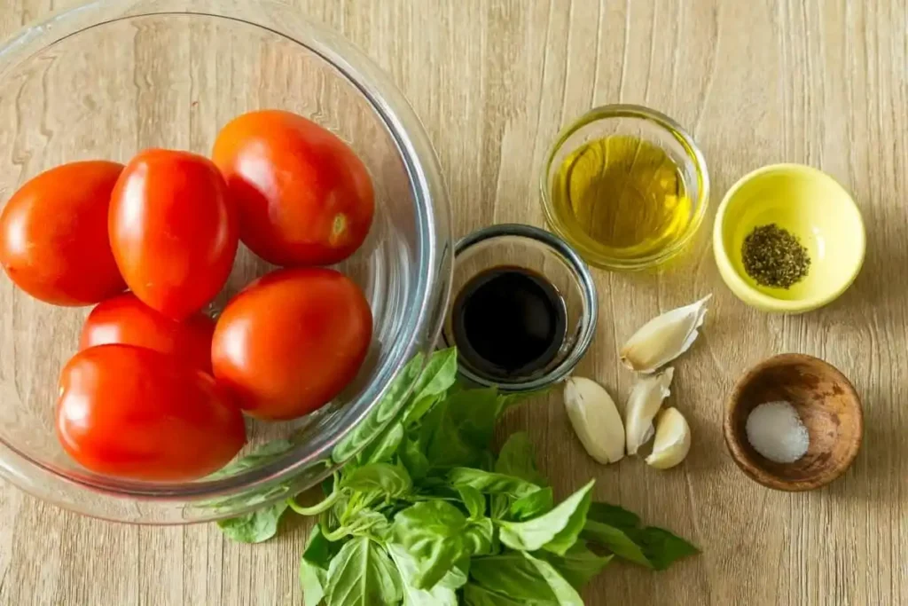 Zutaten für Bruschetta mit Tomaten: Roma-Tomaten, Basilikum, Knoblauch, Olivenöl, Balsamico, Salz und Pfeffer