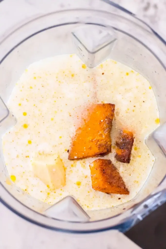 Geröstete Hokkaido-Stücke mit Kokosmilch, Gemüsebrühe und frischem Ingwer im Standmixer.