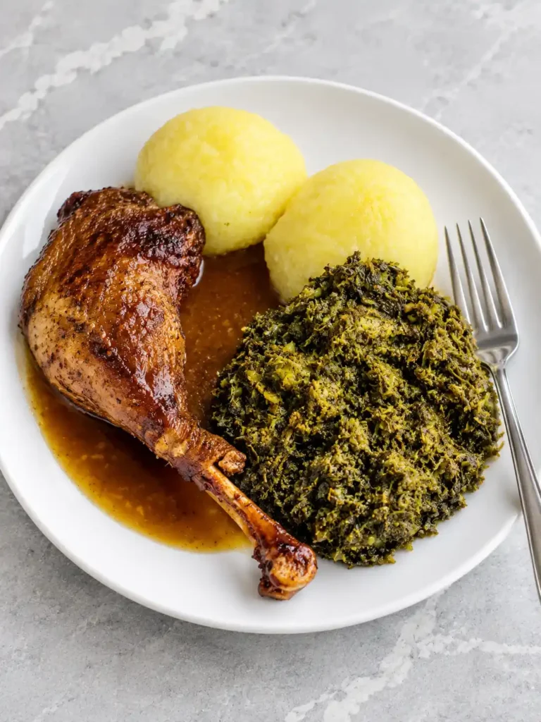Klassisch zubereiteter Grünkohl mit Kartoffelklößen, Geflügelkeule und Bratensoße wie bei Oma